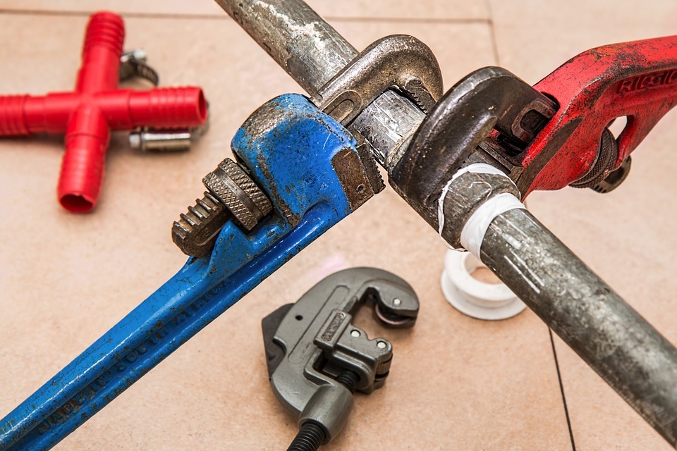 blue and red plumbing wrench, red pipe, steel tube