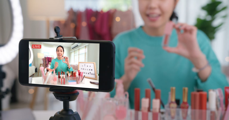 woman-doing-a-live-stream-video-online-via-smartphone-768x405