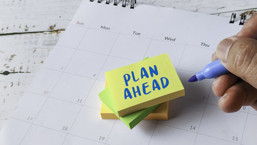 Plan Ahead Future Strategy Concept with Hand Writing on Sticky Notes Placed on Calendar