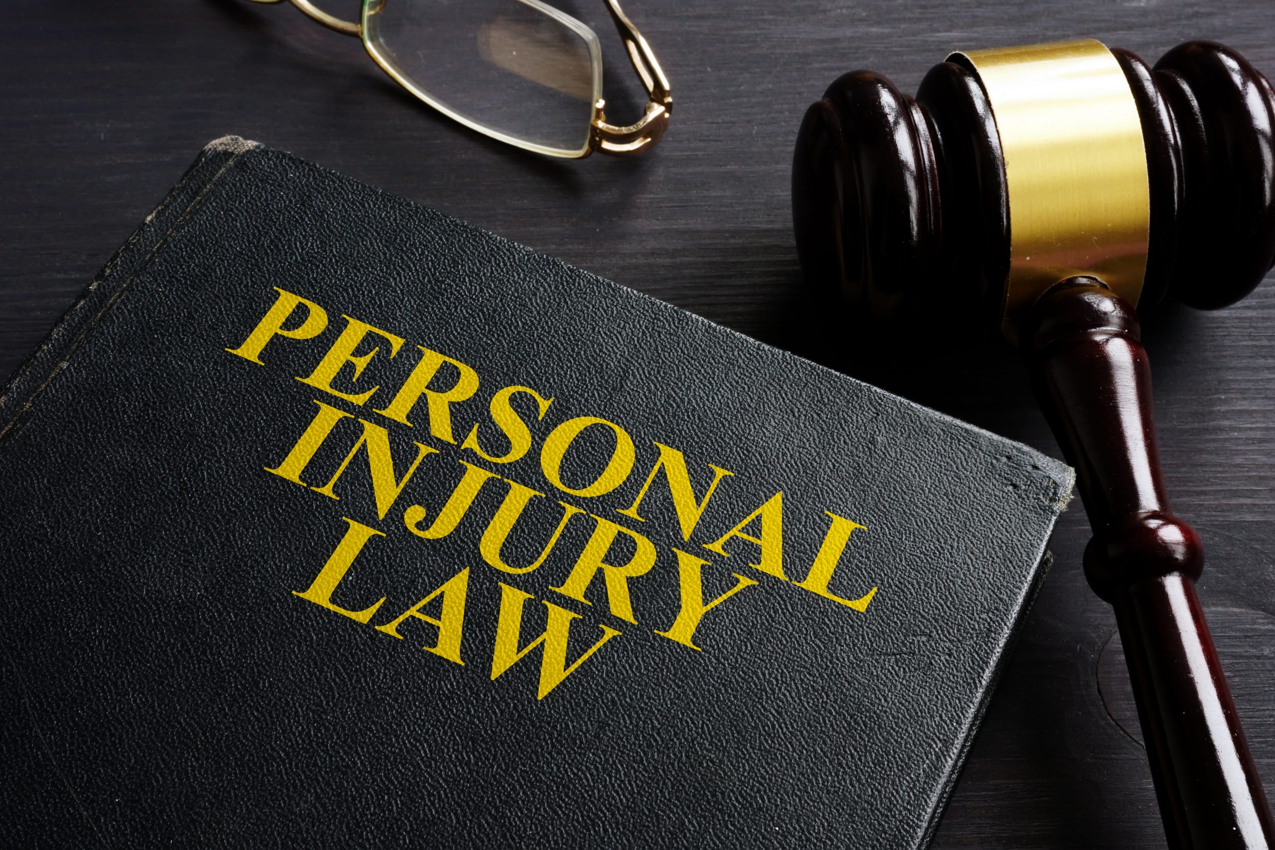 Personal Injury Law book and a black desk.