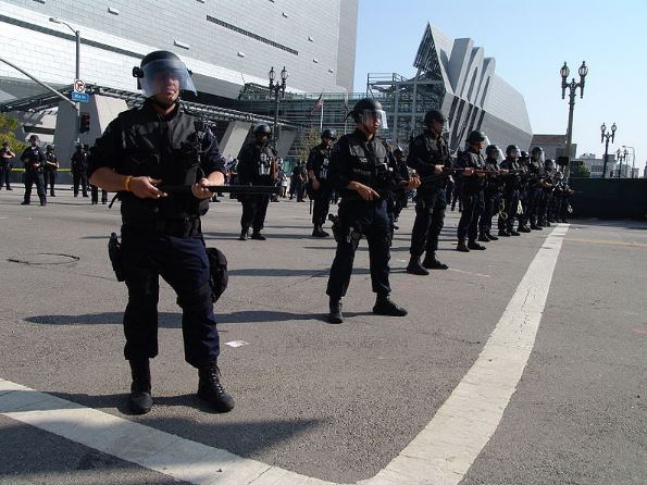 Police officers holding black batons