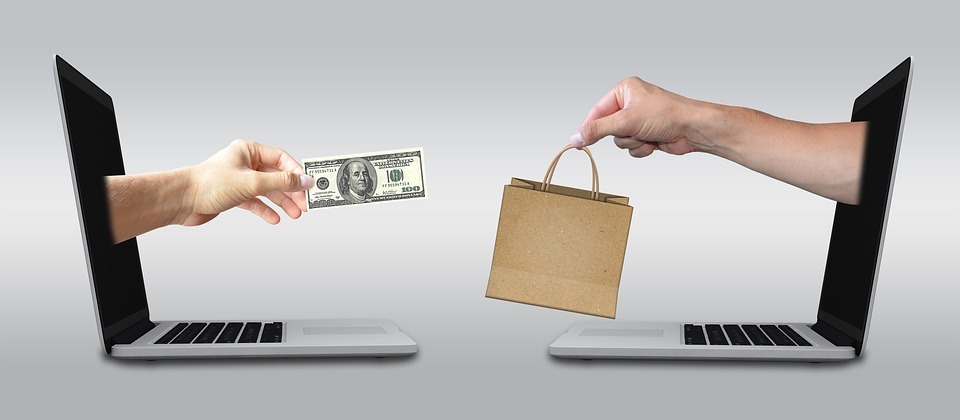 two laptops facing each other, two arms inside the laptop screen, two people exchanging money and paper bag